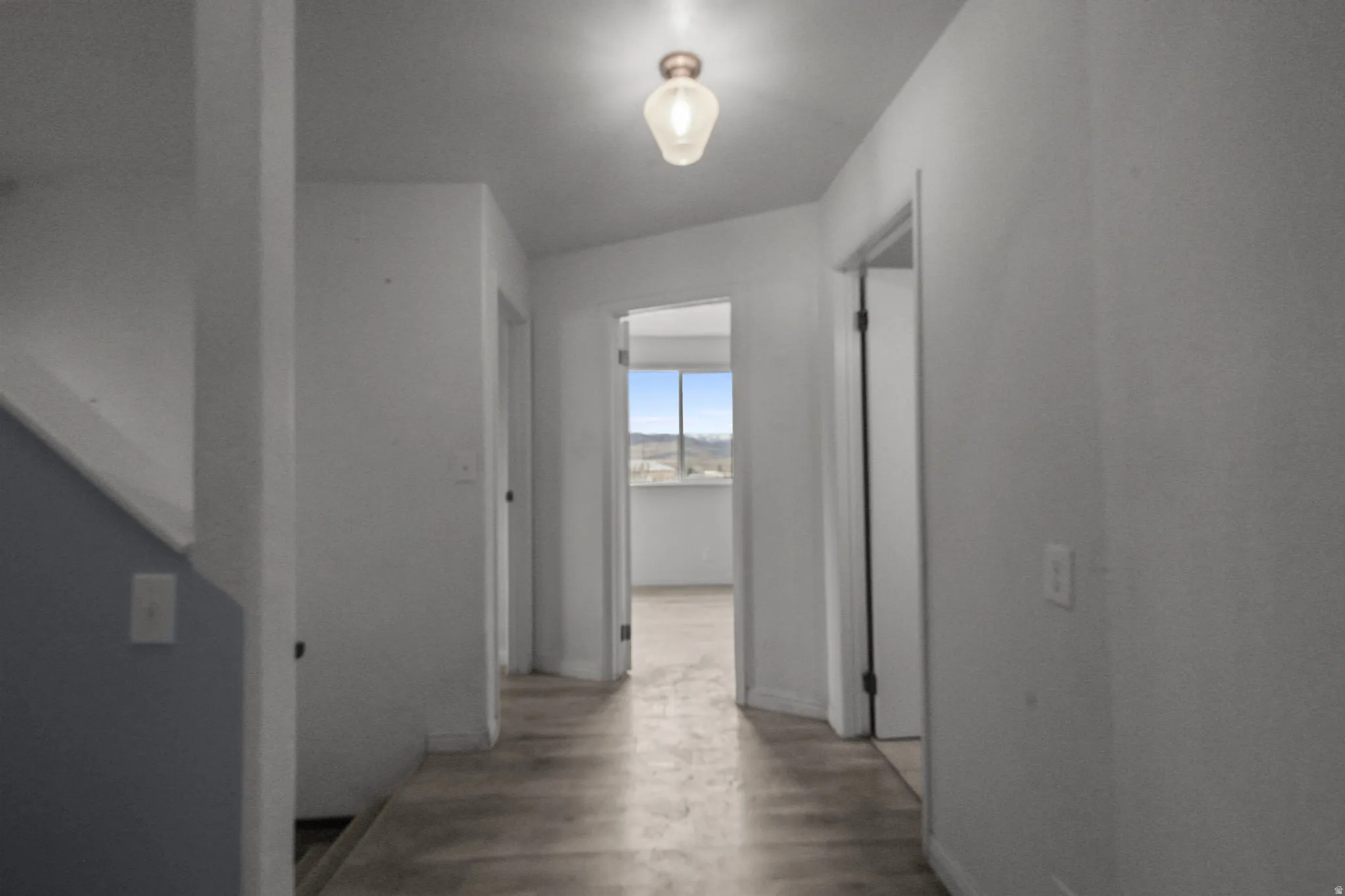 Hallway with wood finished floors and baseboards