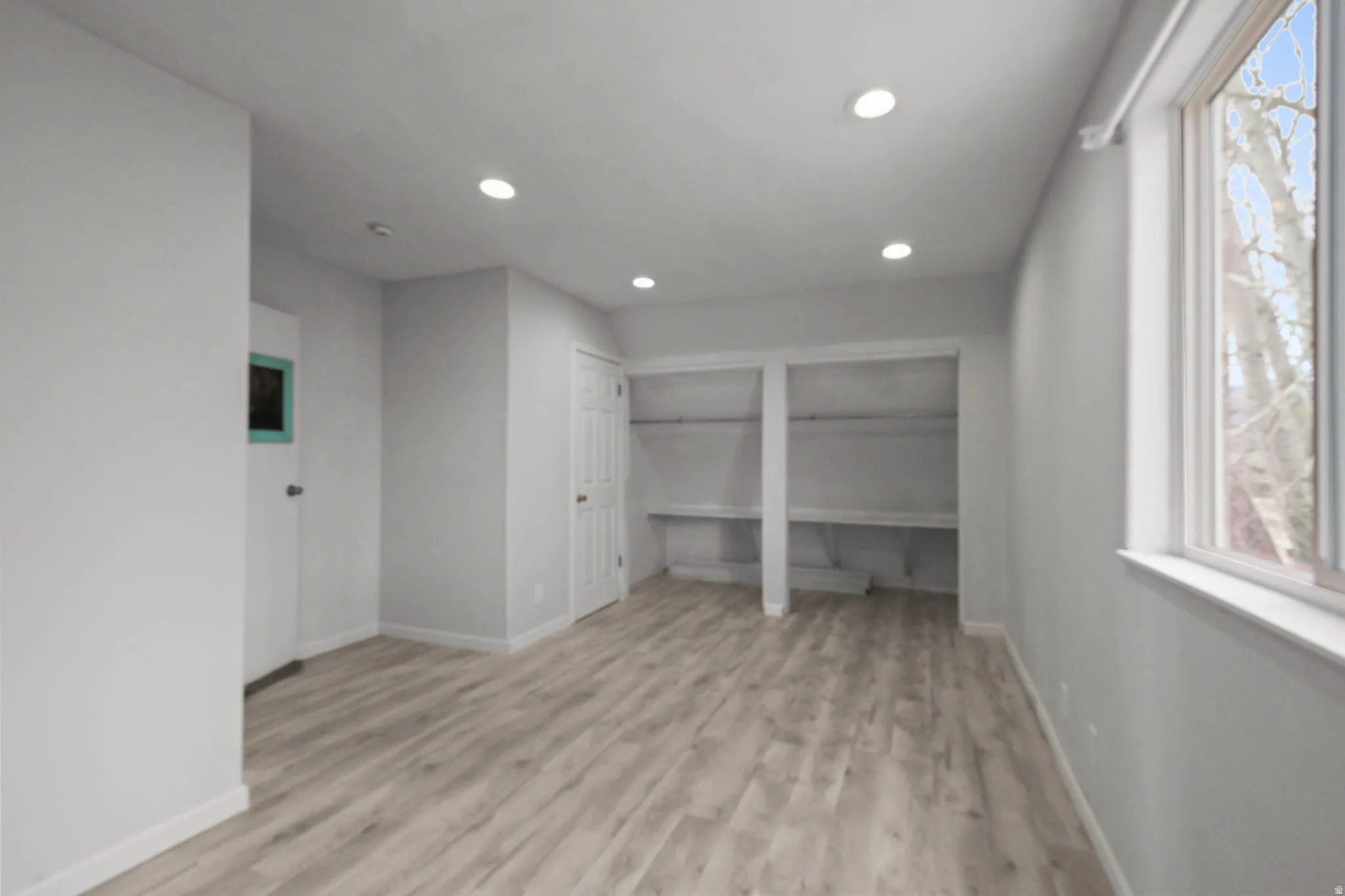Unfurnished bedroom with multiple closets, light wood-style flooring, and recessed lighting