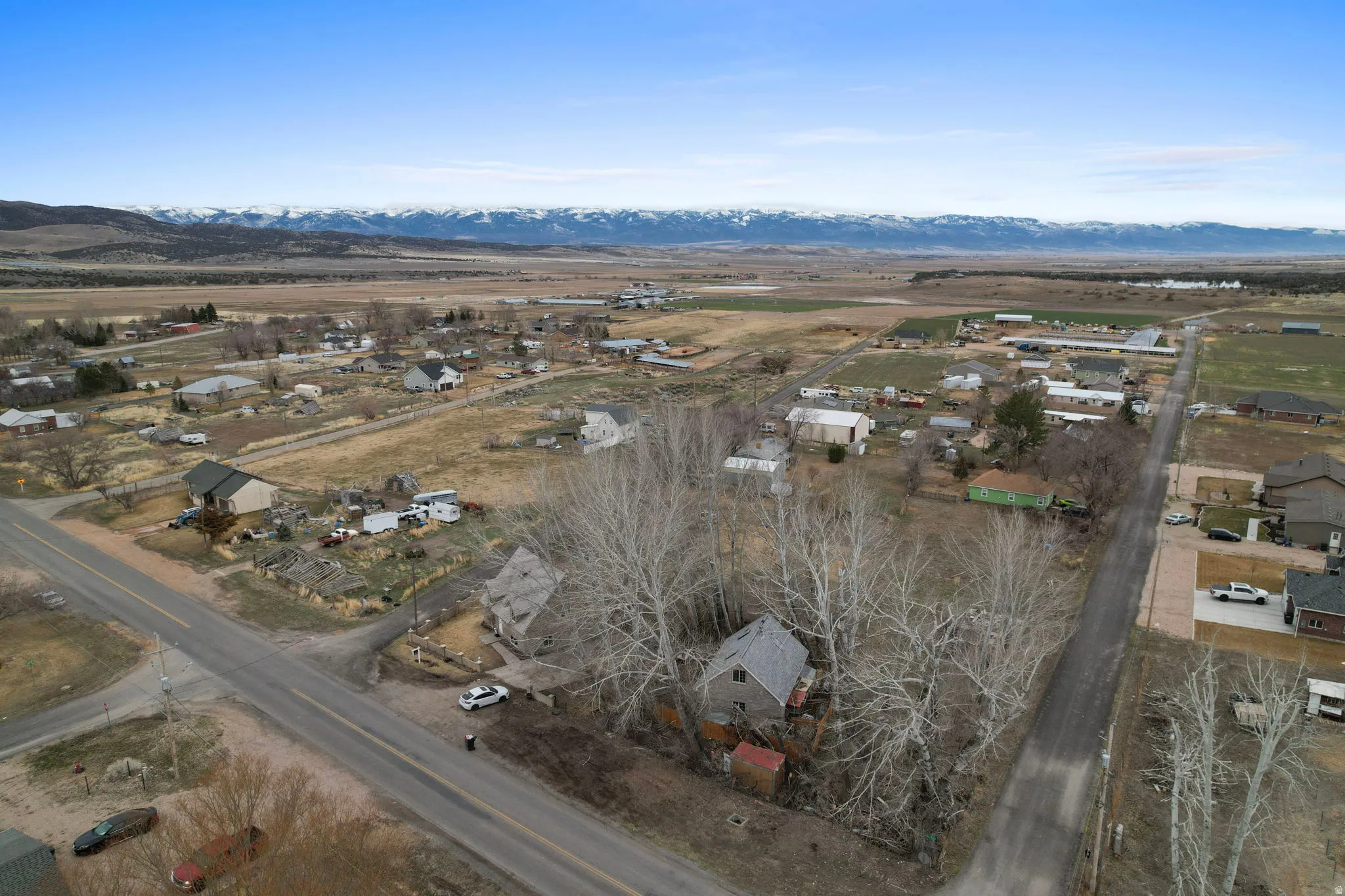 Aerial overview of property's location with a mountain backdrop and nearby suburban area