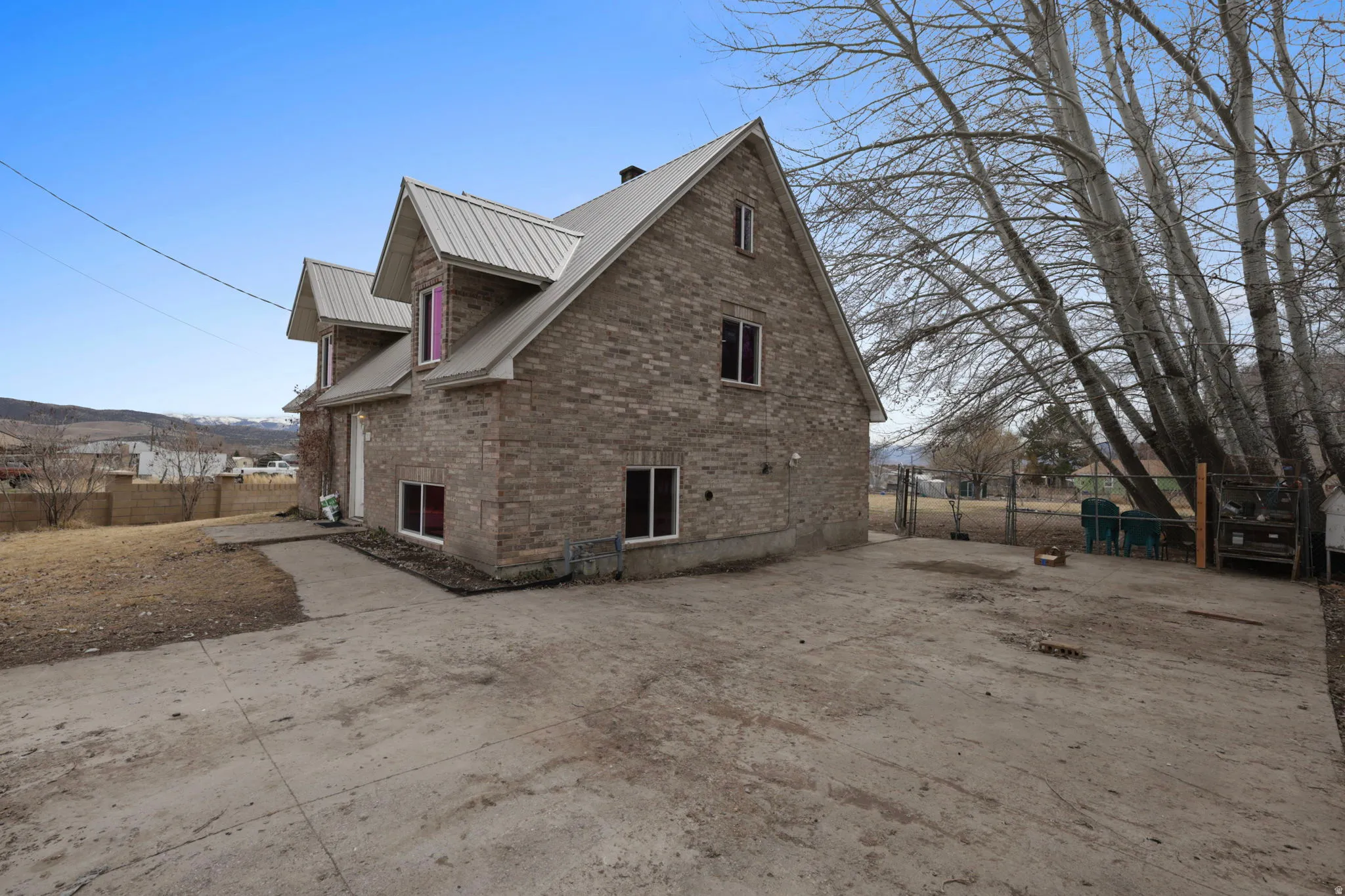 View of home's exterior with brick siding and a metal roof