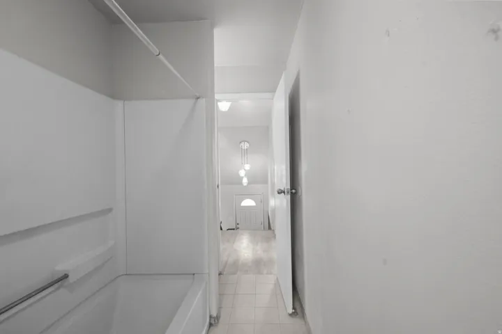 Bathroom featuring shower / washtub combination and light tile patterned floors