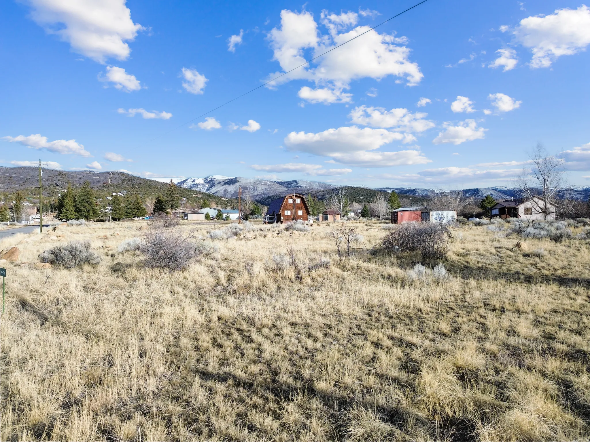 View of yard with a mountain view, a view of countryside, and an outdoor structure