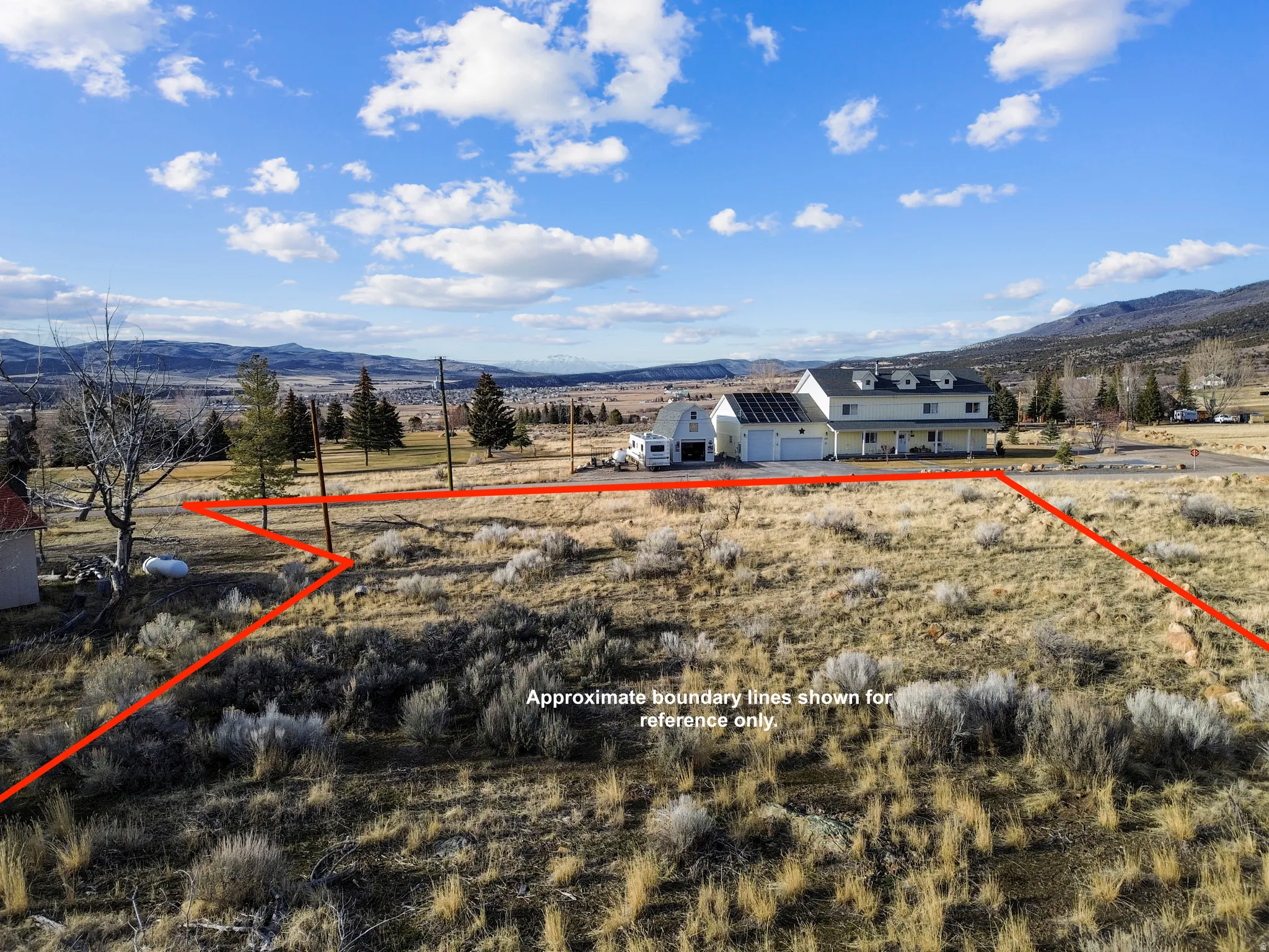 View of rural area with a mountain backdrop and property boundaries highlighted