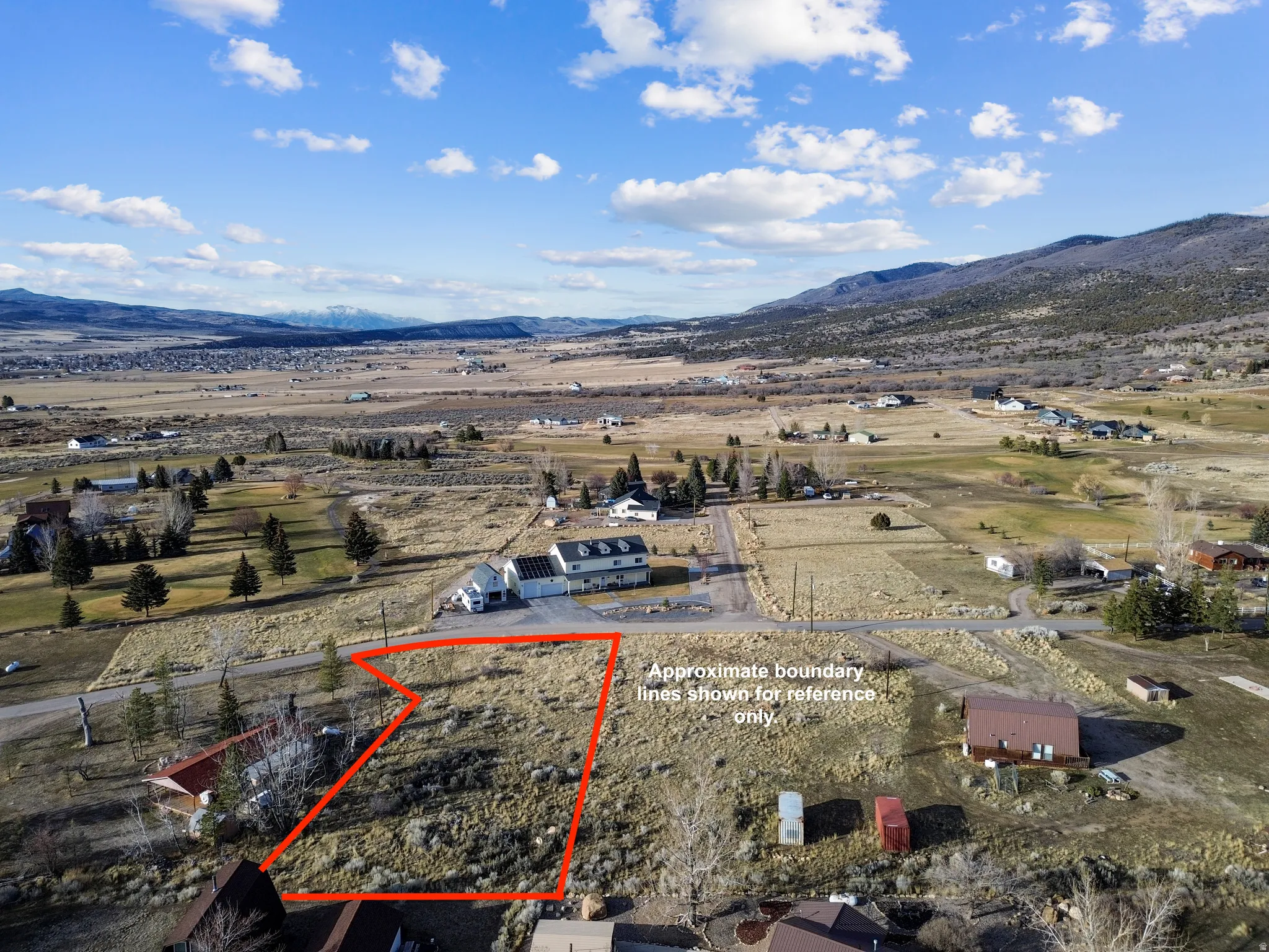 Overview of rural landscape with a mountainous background and property boundaries highlighted