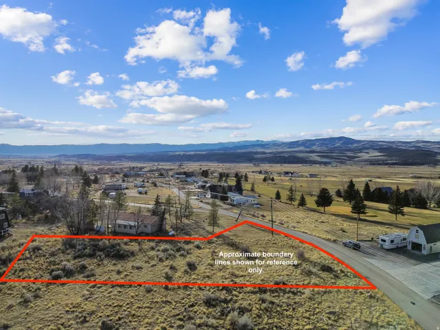 Overview of rural landscape featuring property parcel outlined and mountains