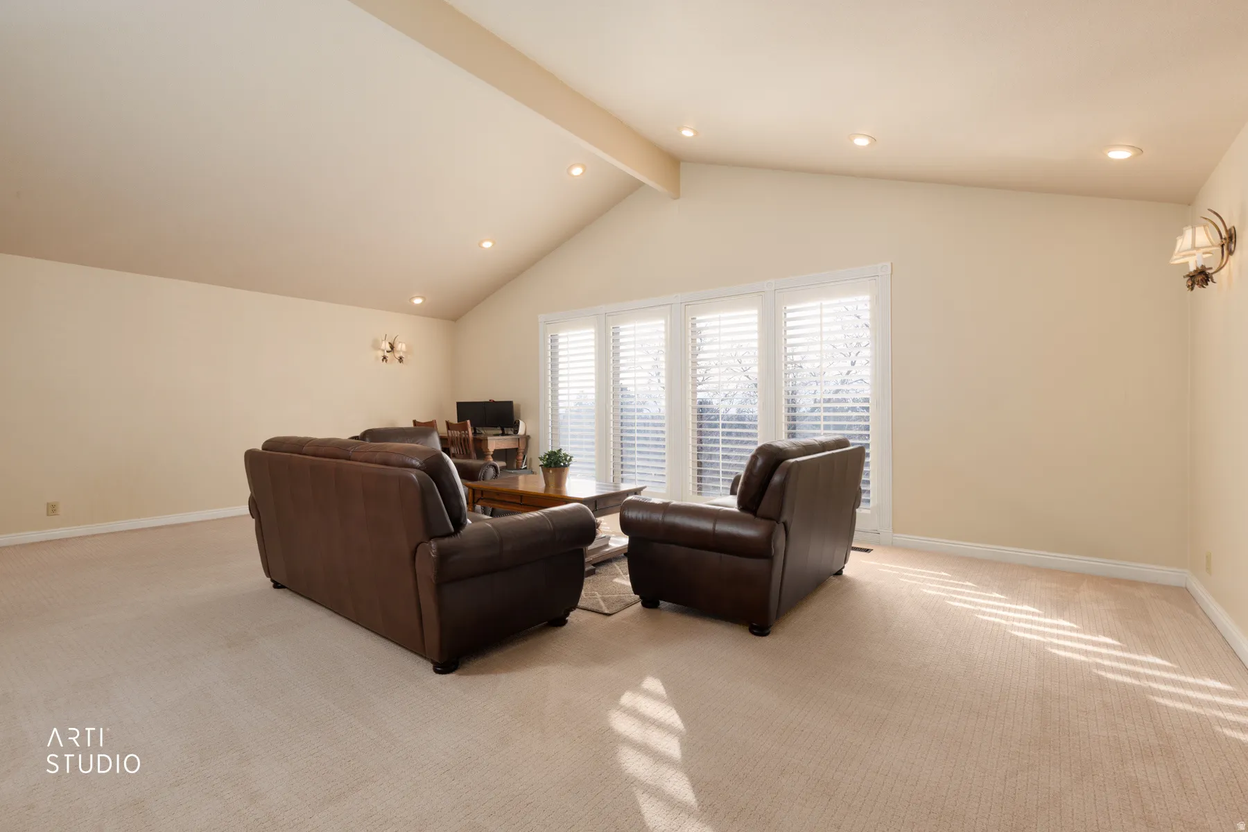 Living room featuring light colored carpet, recessed lighting, and beam ceiling
