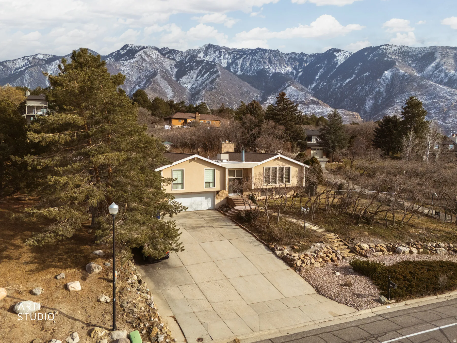 View of front of house with a garage, a mountain view, and concrete driveway