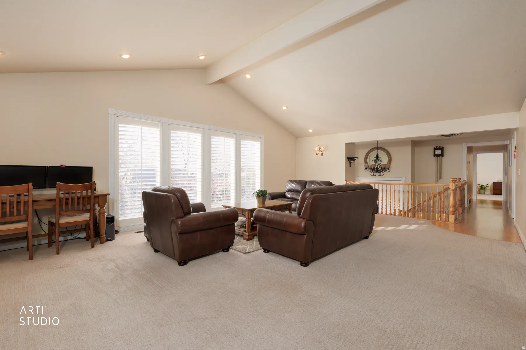 Living area with light colored carpet, recessed lighting, and beam ceiling