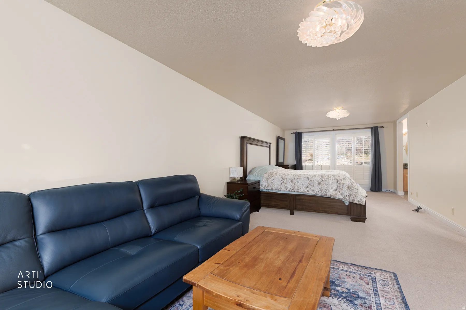 Bedroom with light colored carpet and baseboards