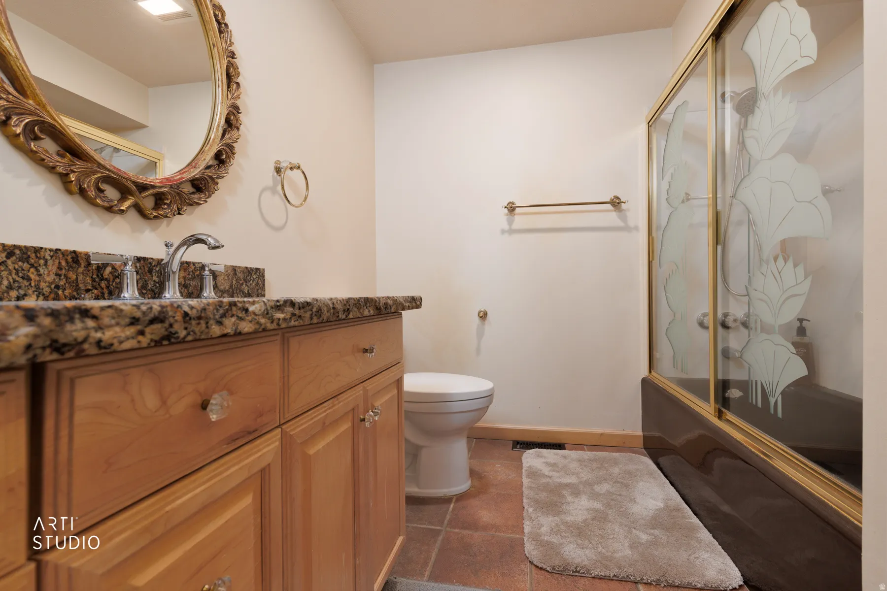 Bathroom with vanity and bath / shower combo with glass door