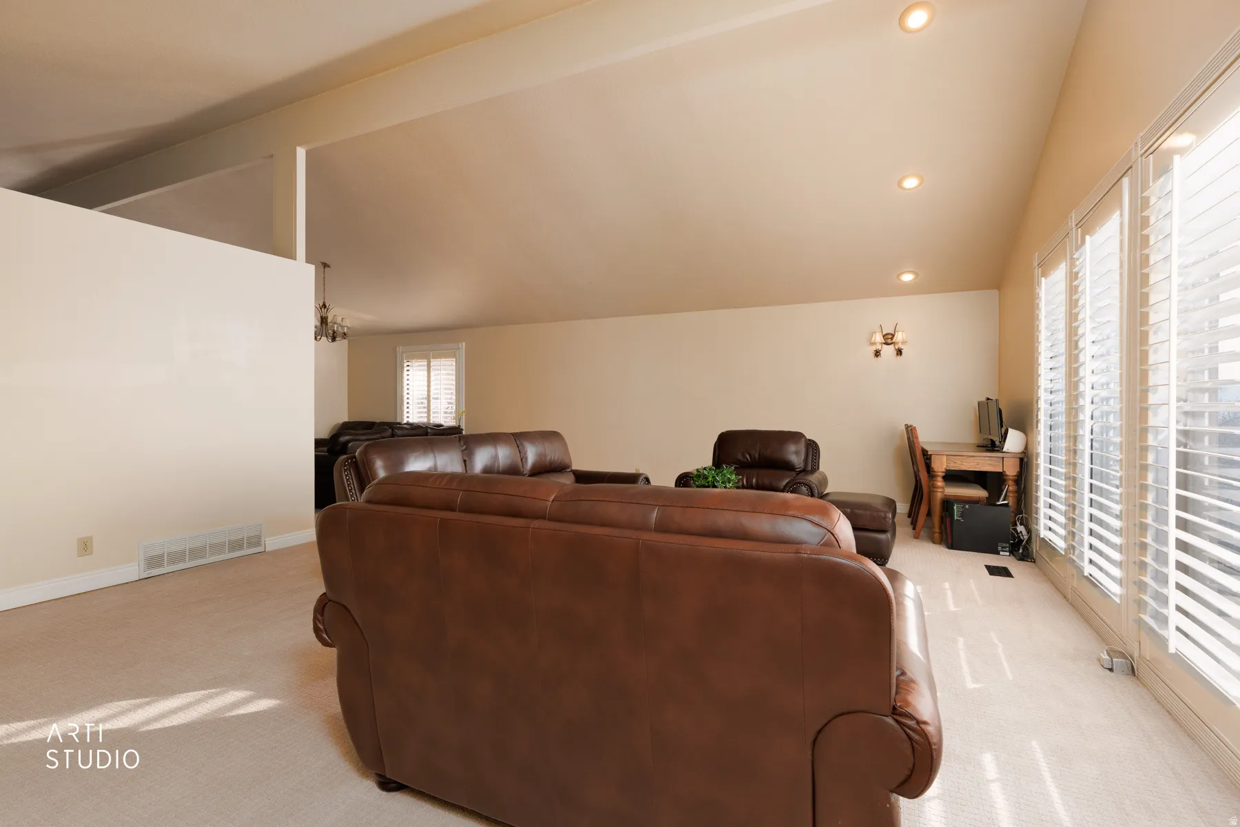 Living area featuring lofted ceiling with beams, carpet flooring, and recessed lighting