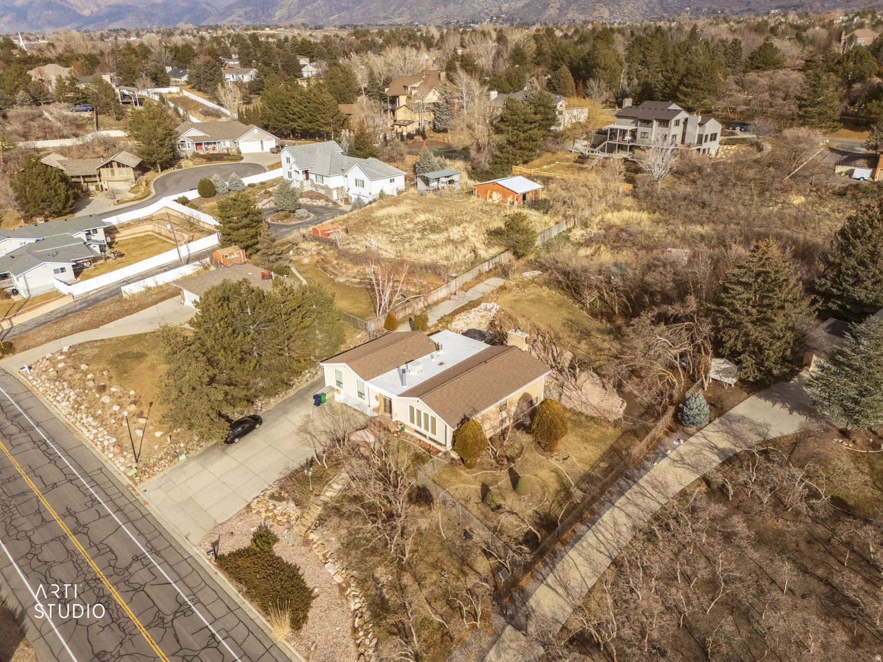 Aerial overview of property's location featuring a mountain backdrop and nearby suburban area