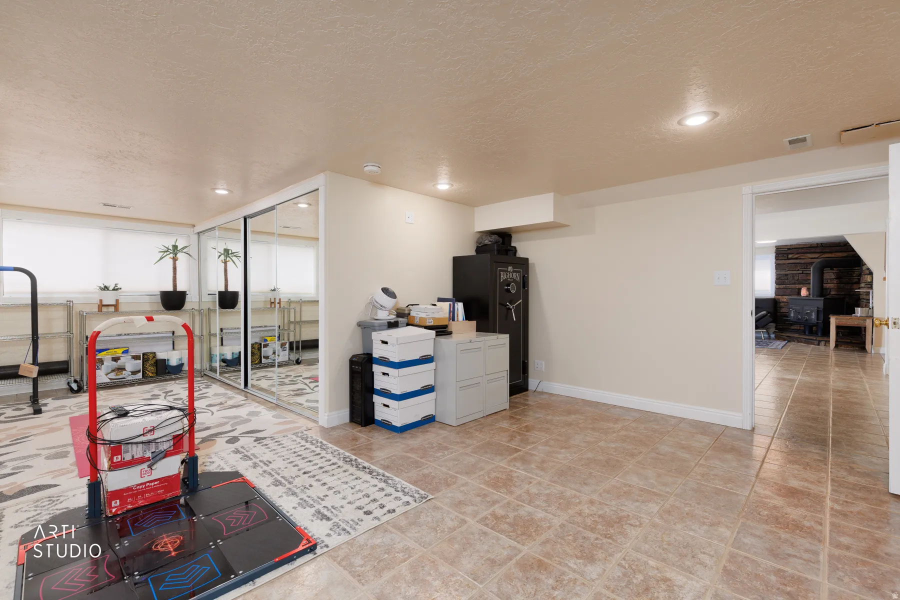 Kitchen with a textured ceiling, a wood stove, and recessed lighting