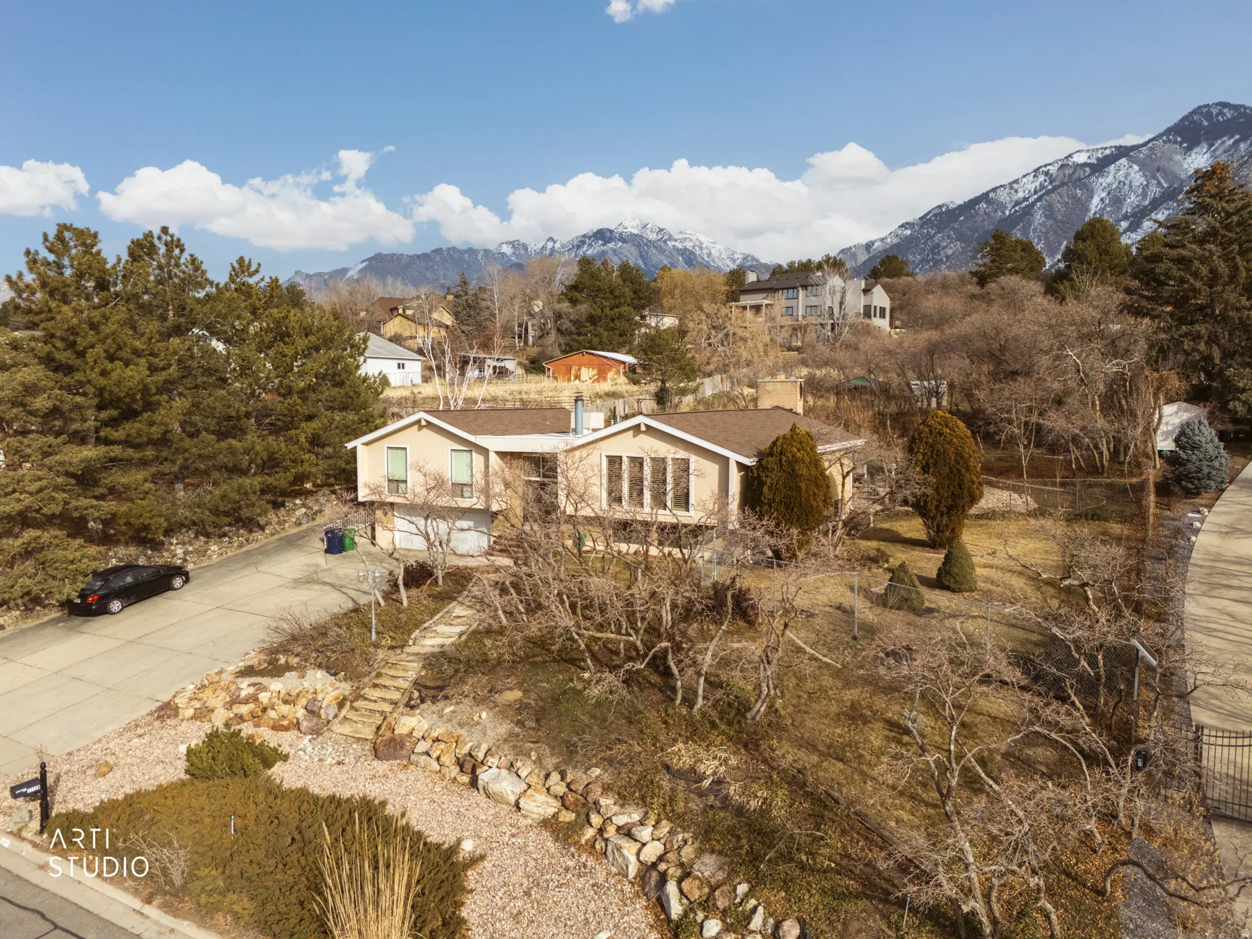 View of front of property with a mountain view and concrete driveway