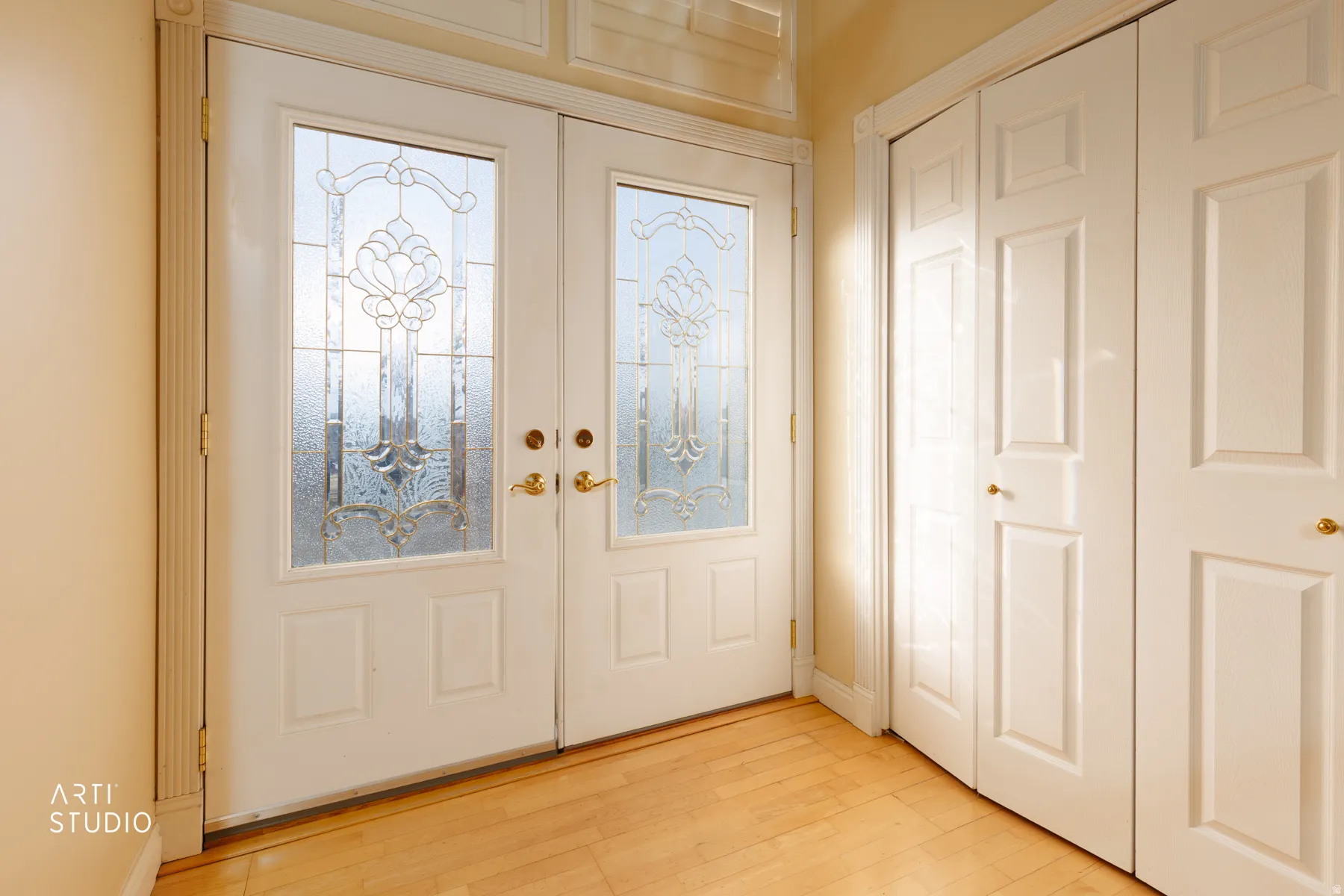 Entryway featuring french doors and light wood-type flooring