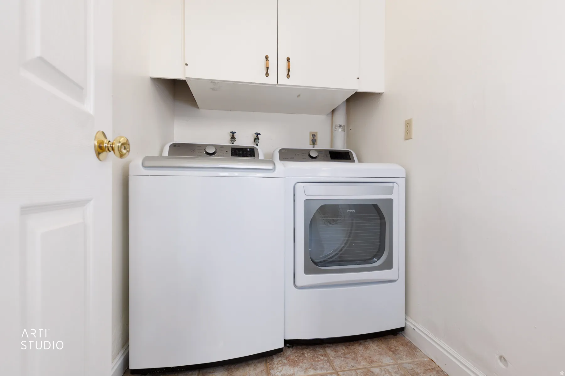 Laundry area featuring cabinet space and washing machine and clothes dryer
