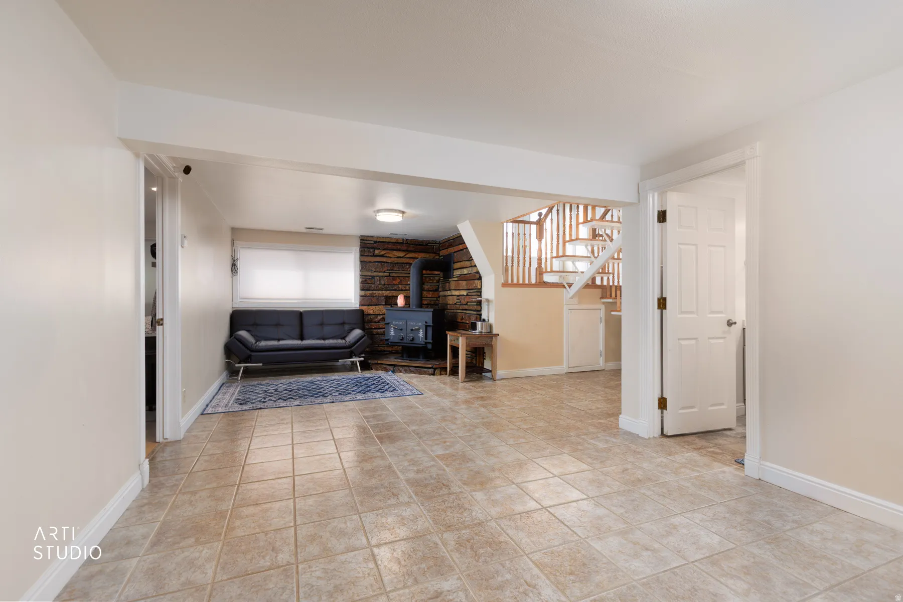 Living area with a wood stove and light tile patterned floors
