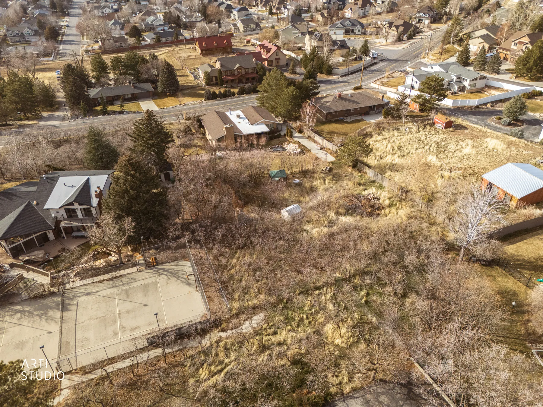 Aerial view of property and surrounding area featuring nearby suburban area