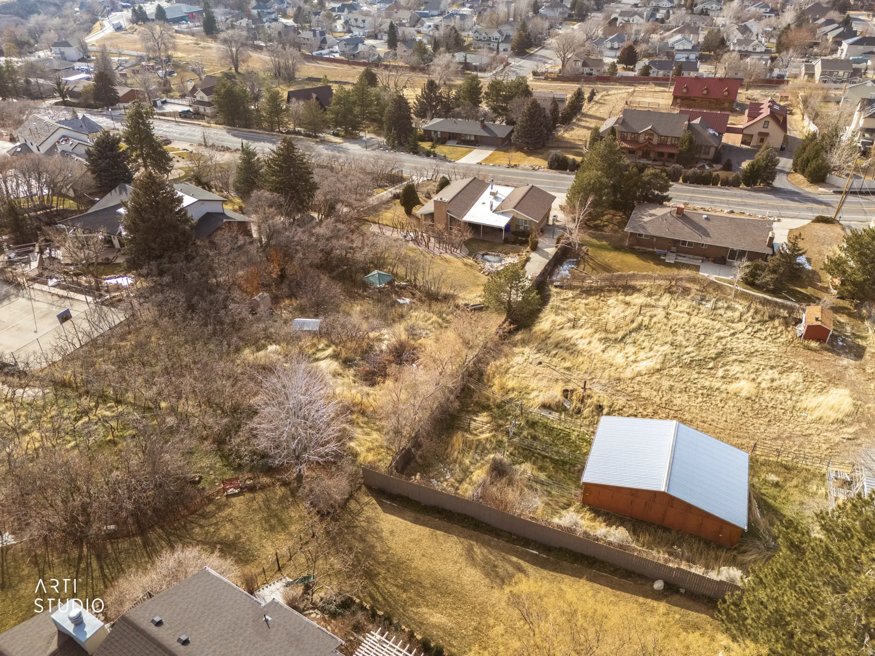 Aerial view of property and surrounding area featuring nearby suburban area