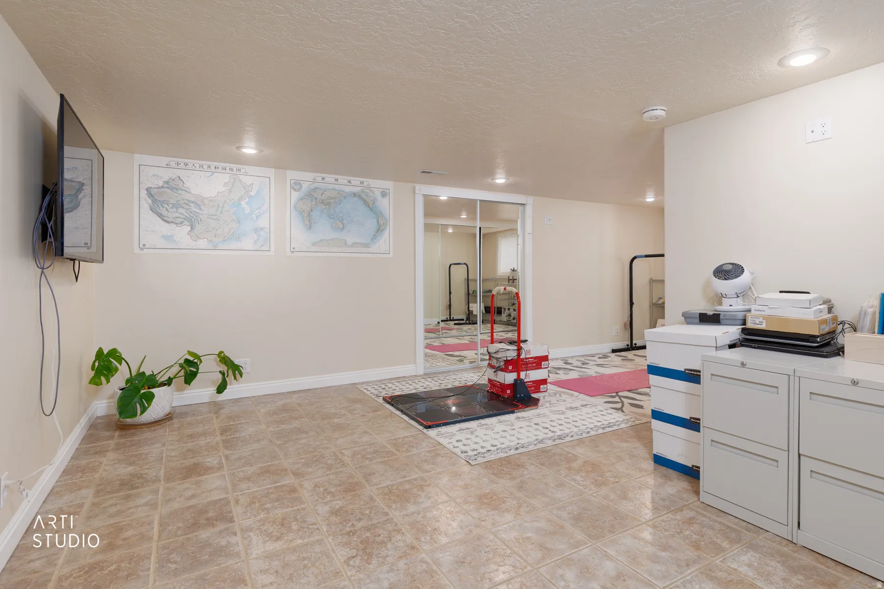 Game room with a textured ceiling, recessed lighting, and light tile patterned floors