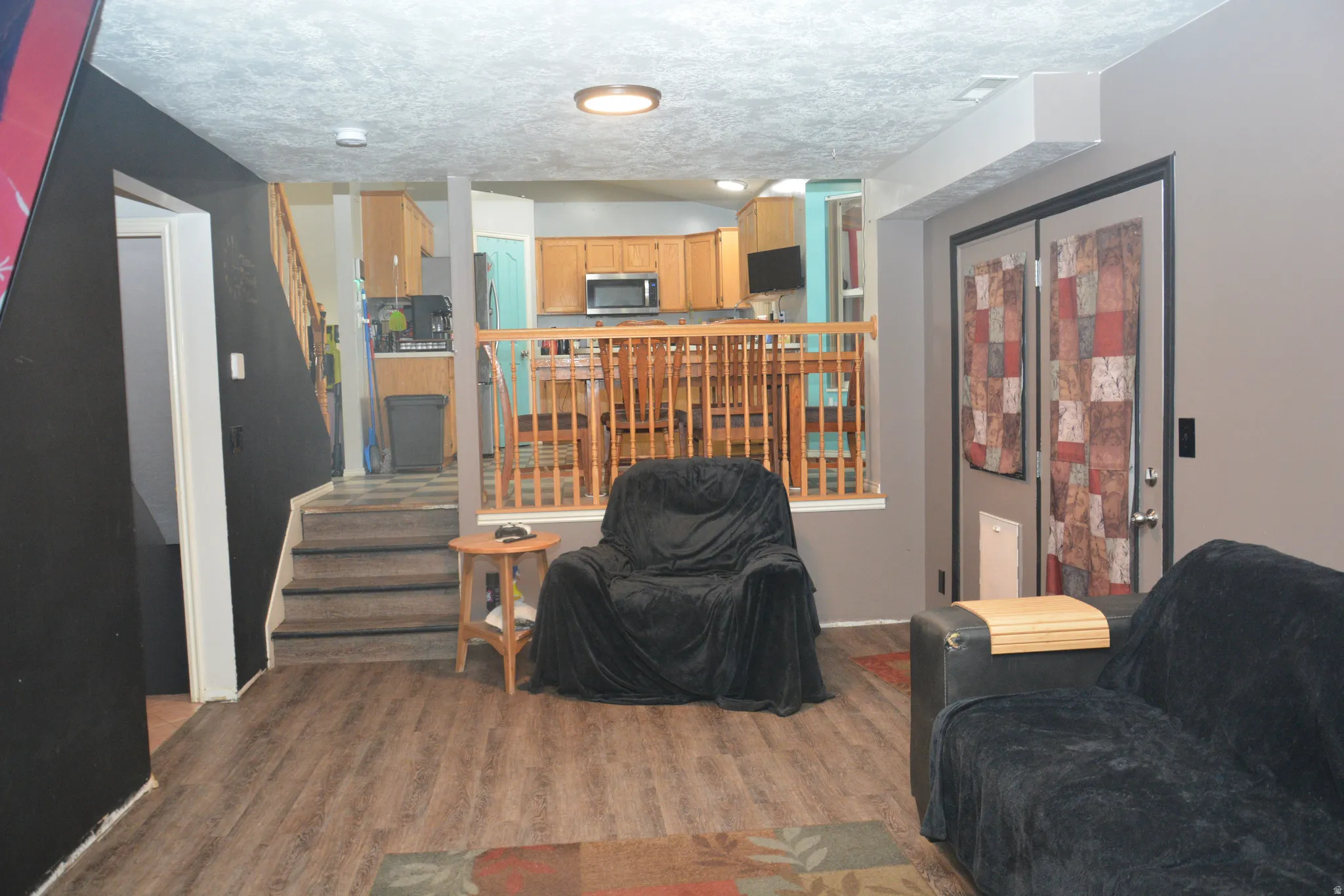 Living room with wood finished floors and a textured ceiling