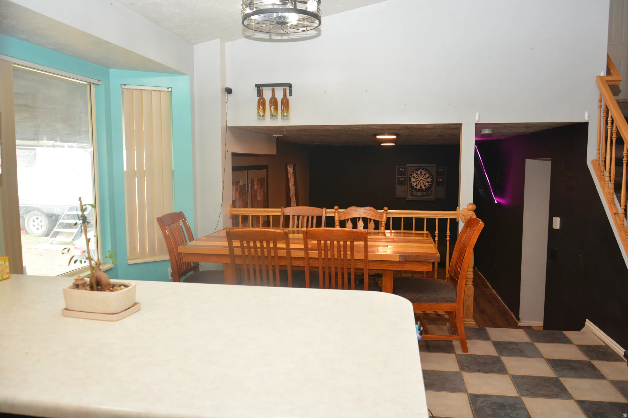 Dining area with light floors and stairs