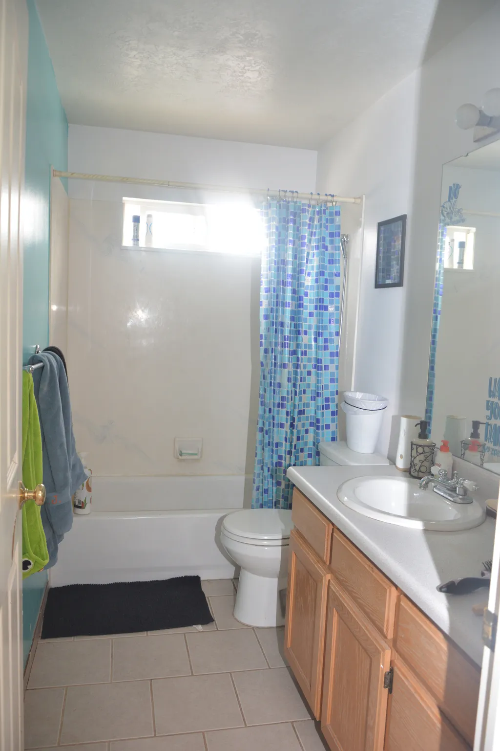 Bathroom with vanity, shower / tub combo with curtain, and light tile patterned floors