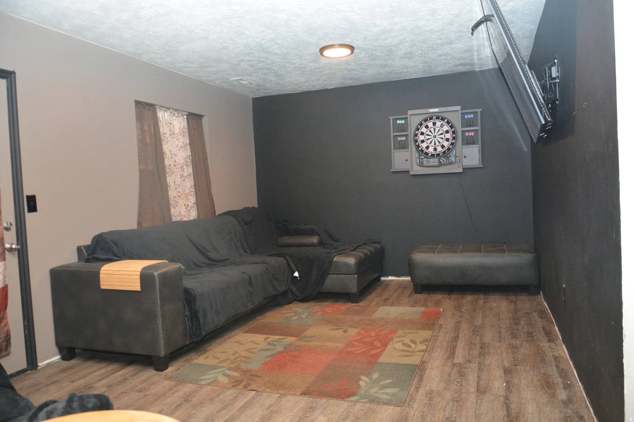 Living room with wood finished floors and a textured ceiling