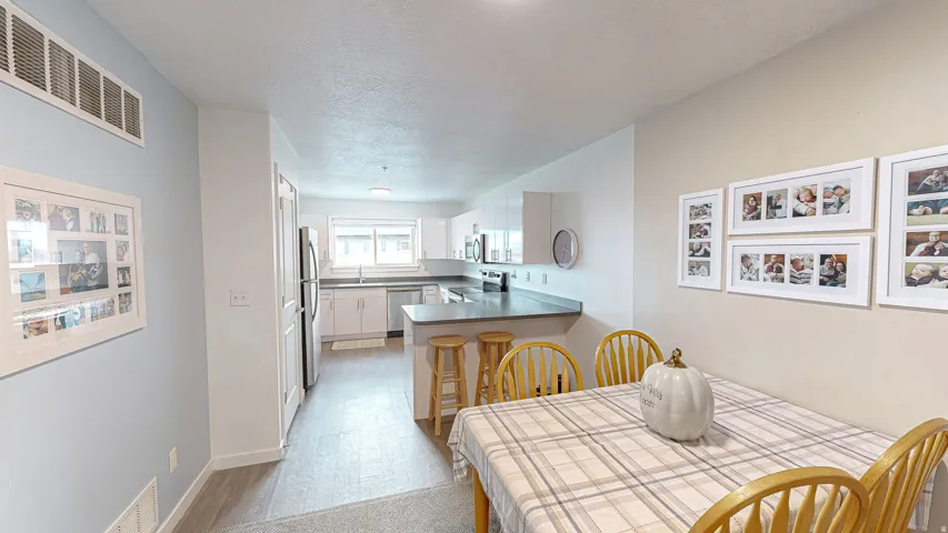 Dining room featuring a textured ceiling and baseboards