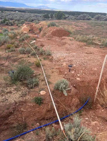 400' of water line (blue) and electrical line (white conduit)