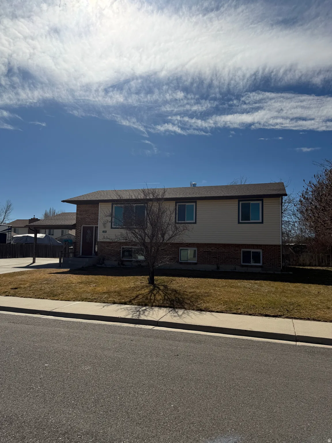 View of front facade featuring brick siding and a front yard