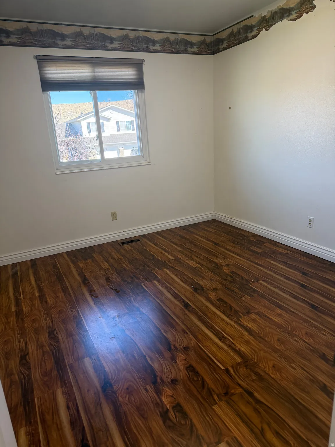 Empty room with dark wood-style floors