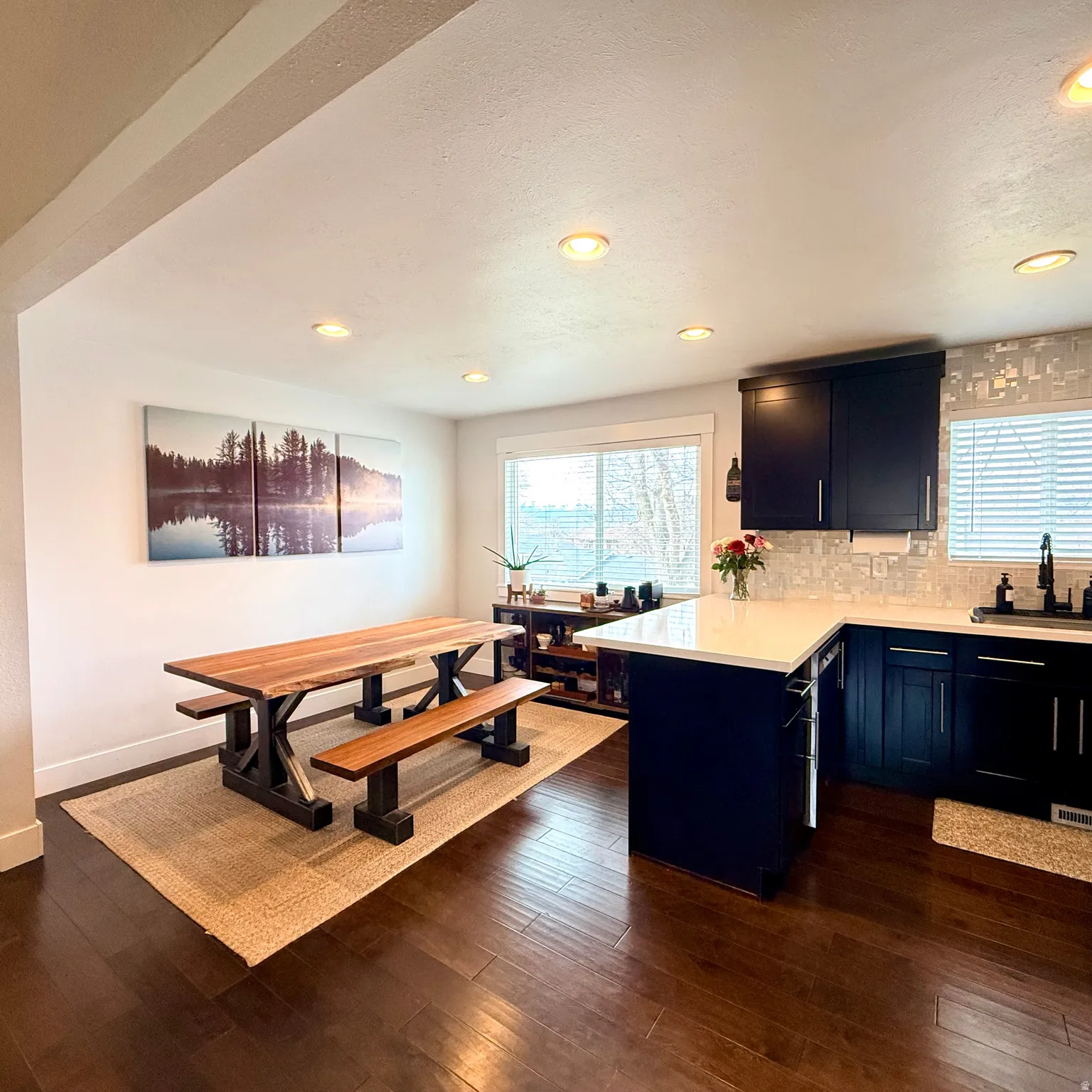 Kitchen featuring a peninsula, decorative backsplash, plenty of natural light, dark wood-style floors, and recessed lighting