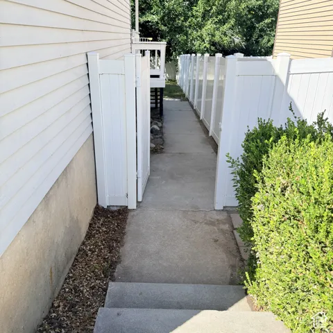 Pathway to backyard from side of garage.