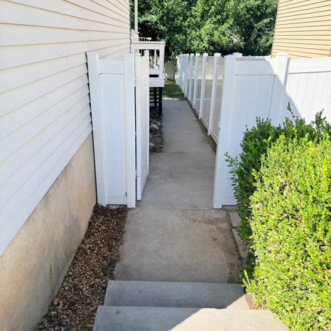 Pathway to backyard from side of garage.