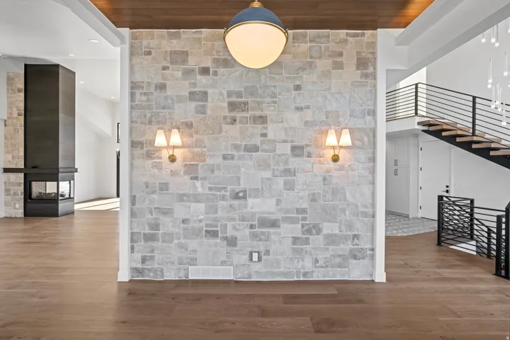 Front entry with wood finished floors, a high ceiling, and recessed lighting