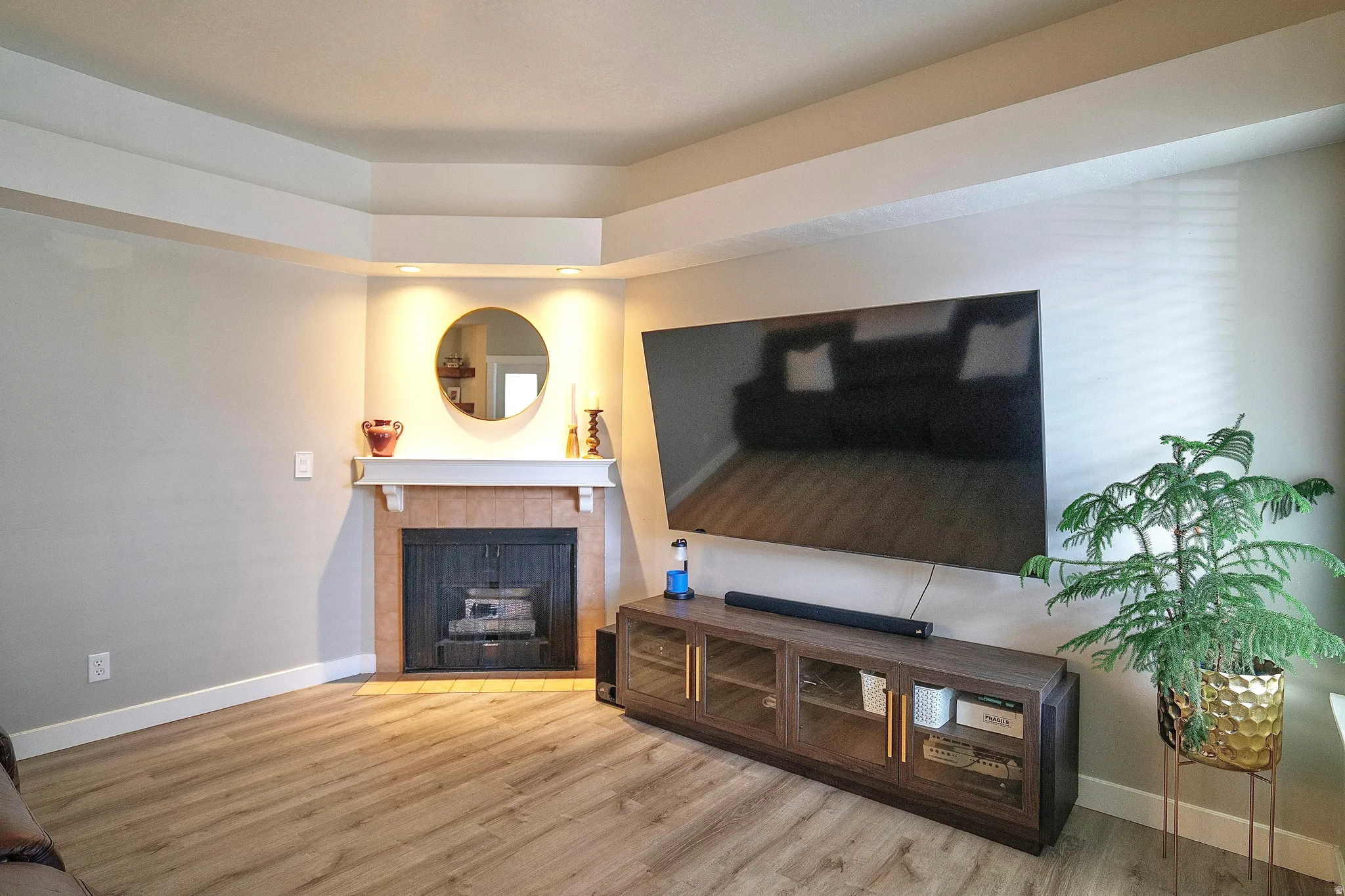 Living area with light wood finished floors and a fireplace