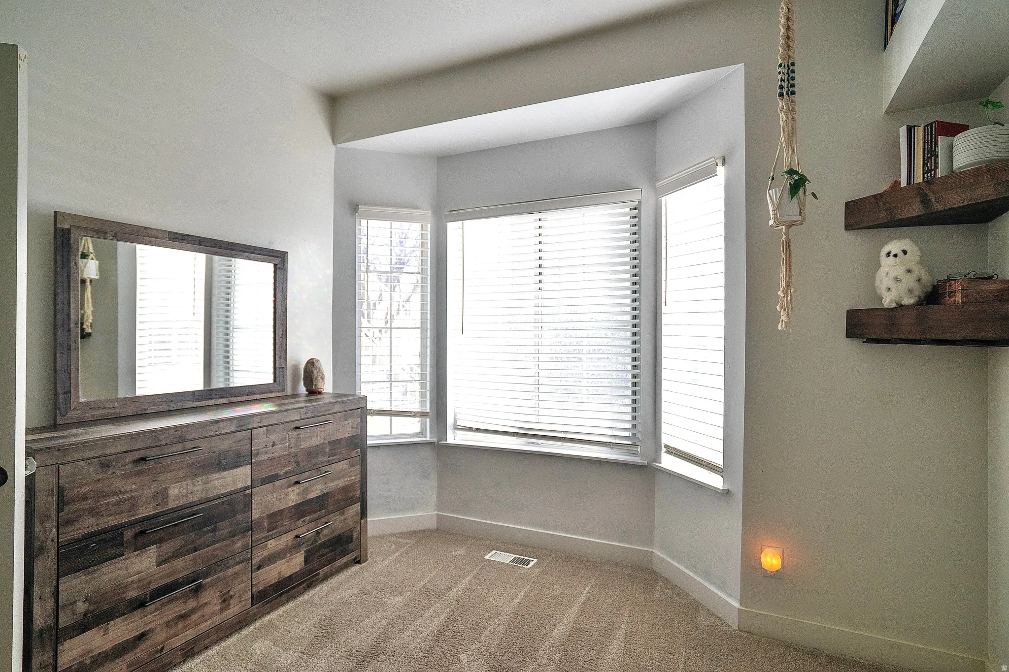 Bedroom featuring dark colored carpet and baseboards