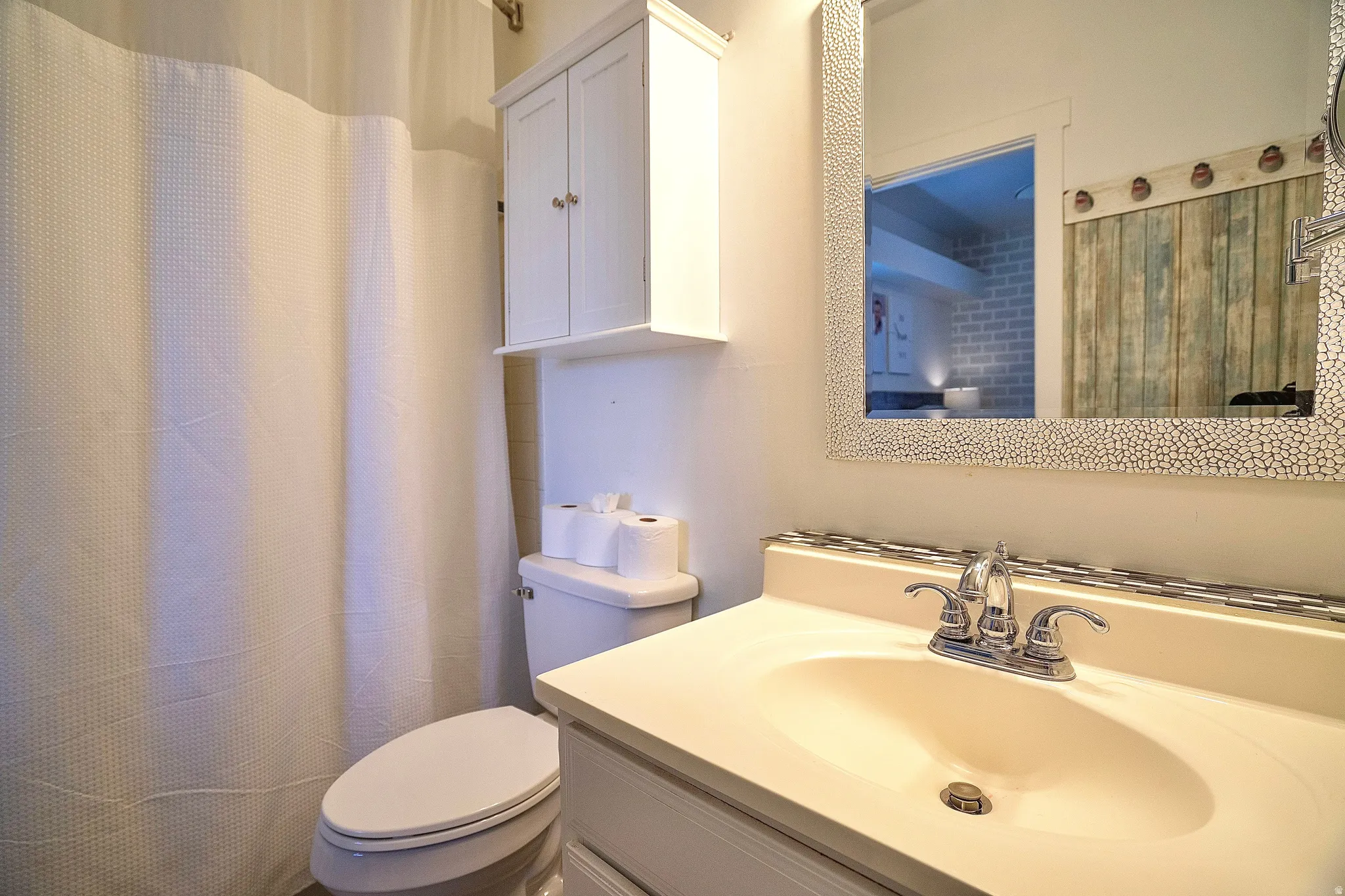 Full bath featuring vanity and a shower with curtain
