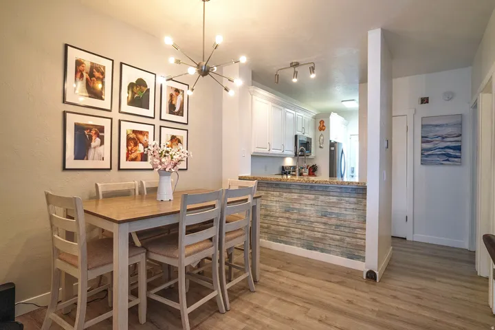 Dining area with hanging lights and light wood-type flooring
