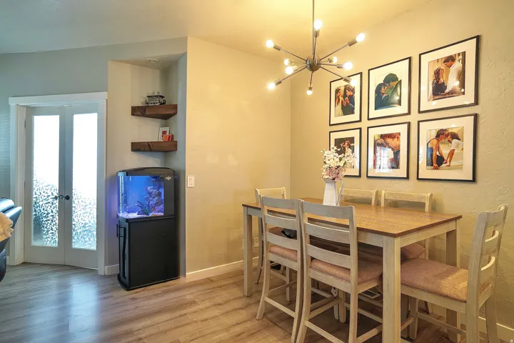 Dining room featuring hanging lights, light wood-style flooring, and french doors