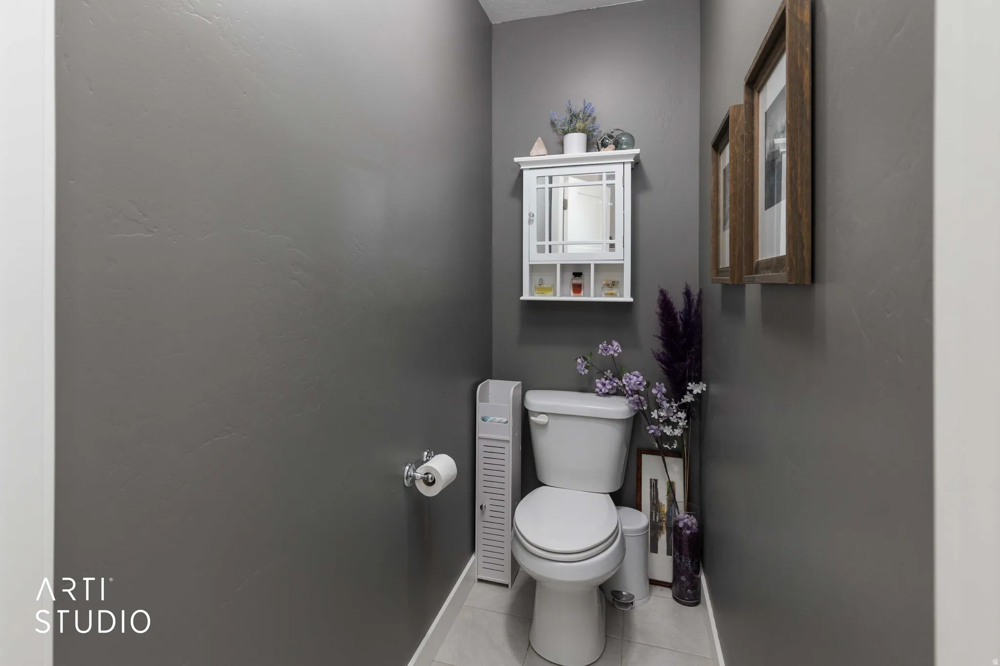 Bathroom with toilet and light tile patterned floors