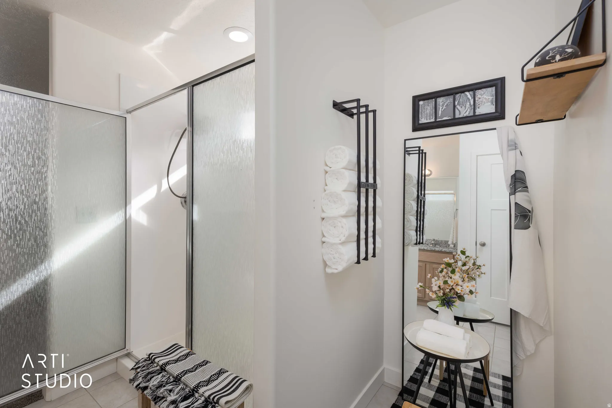 Bathroom featuring light tile patterned flooring and a shower stall