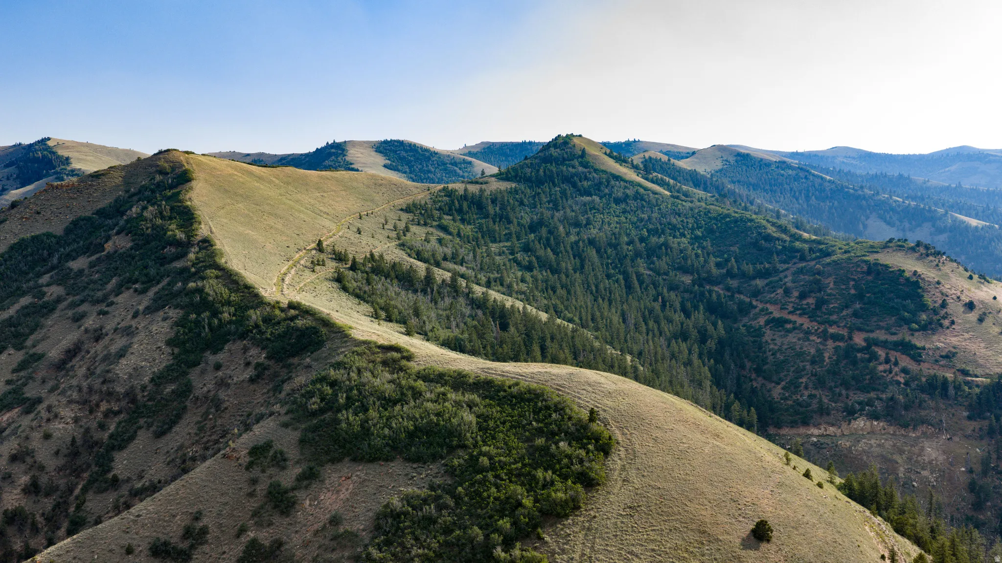 Expansive mountain landscape featuring varied terrain and natural vegetation