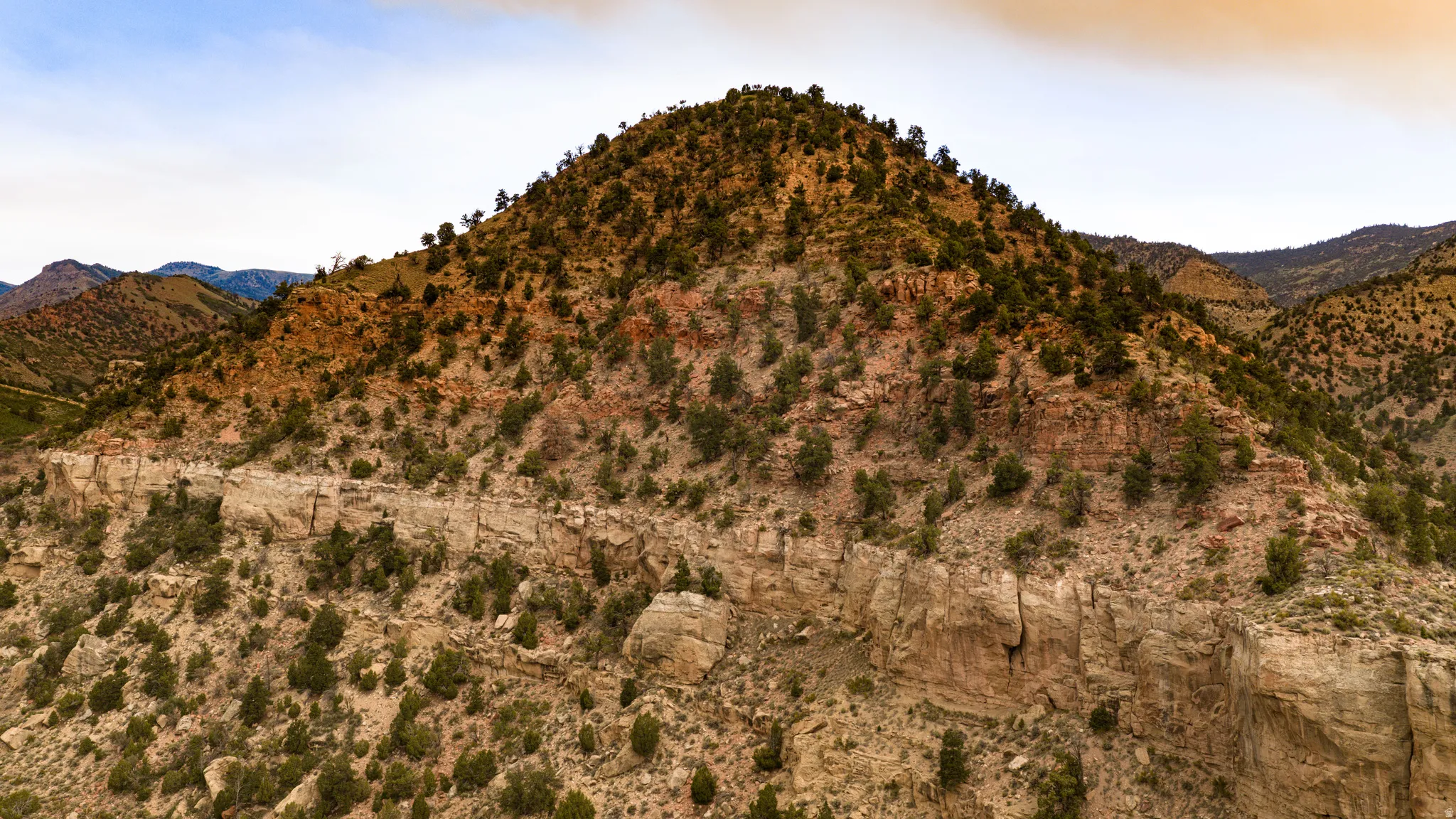 Mountainous terrain featuring diverse geological layers and abundant natural vegetation
