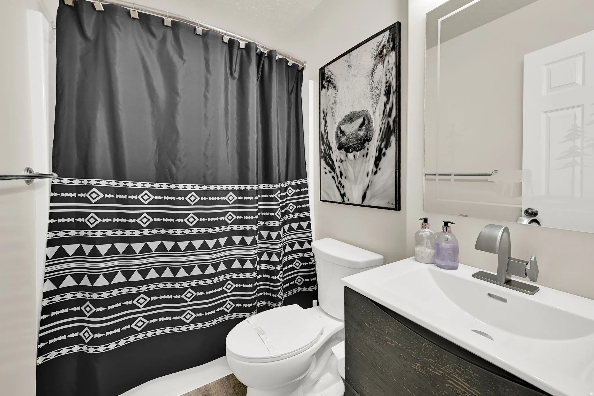 Full bathroom featuring vanity and a shower with shower curtain