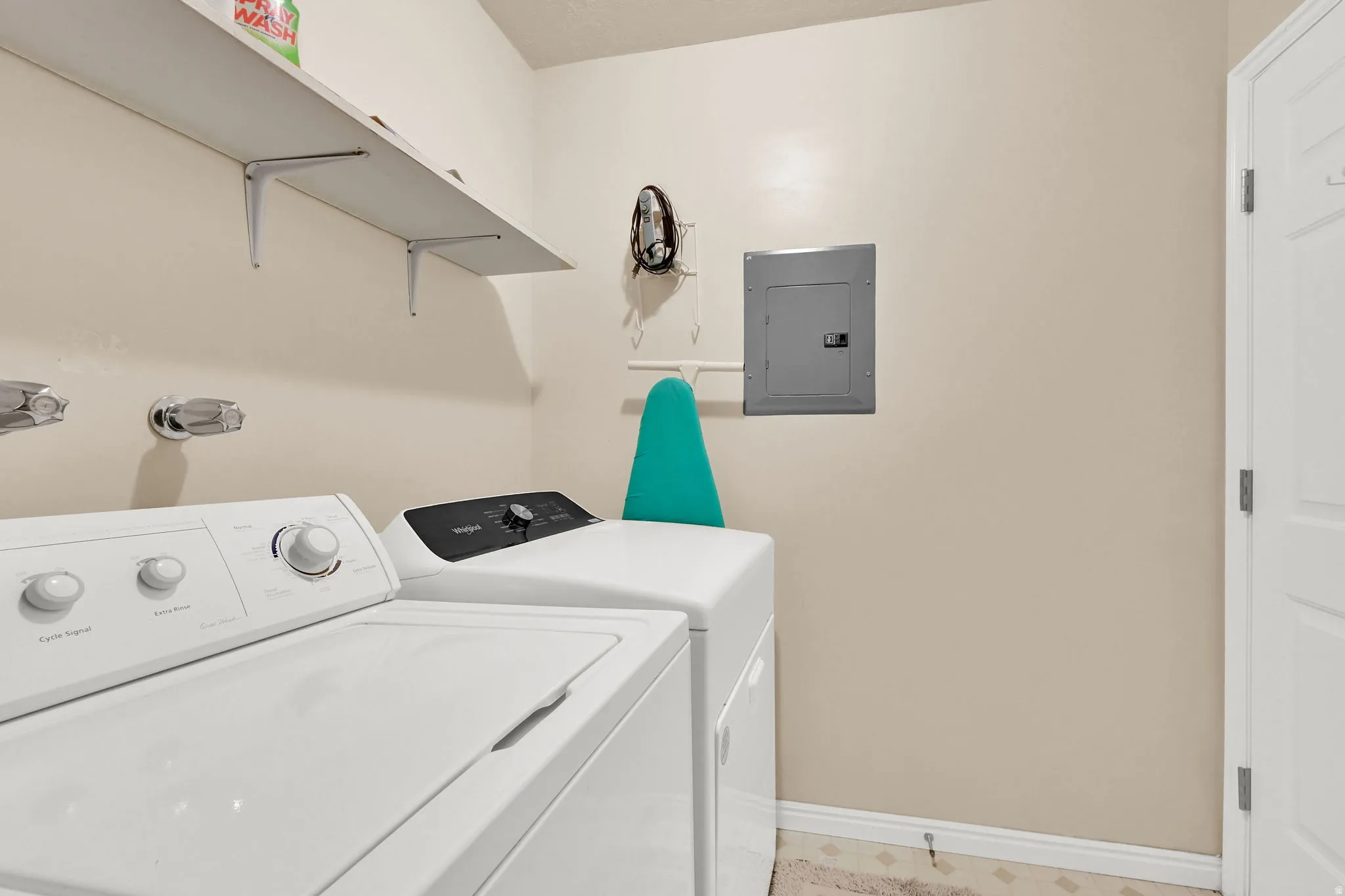 Laundry room featuring light floors, and separate washer and dryer
