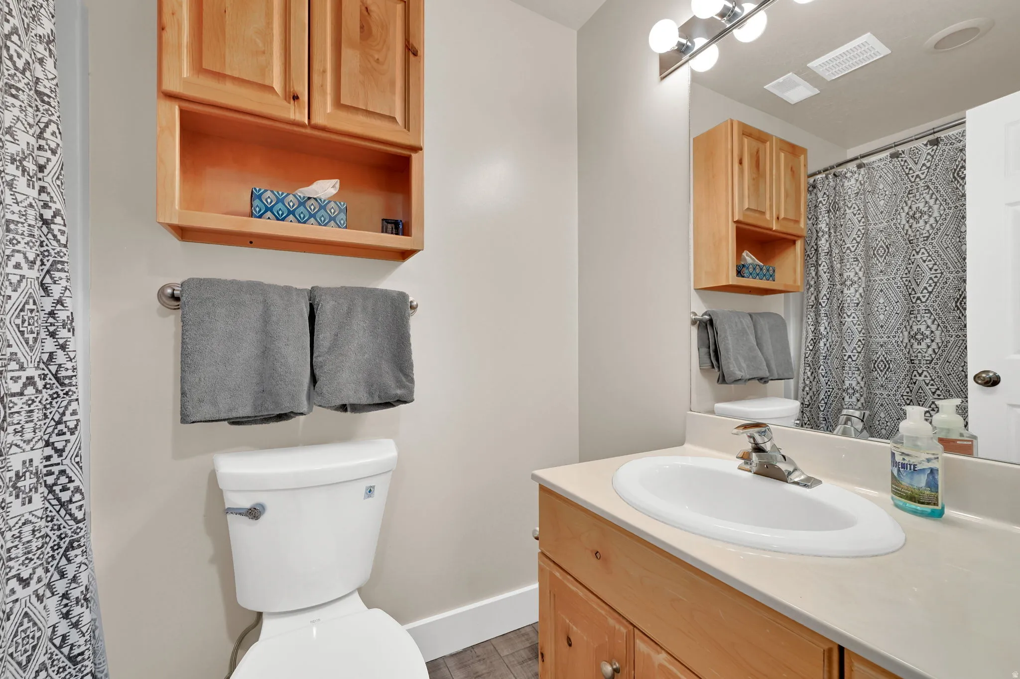 Full bathroom featuring a shower with curtain and vanity