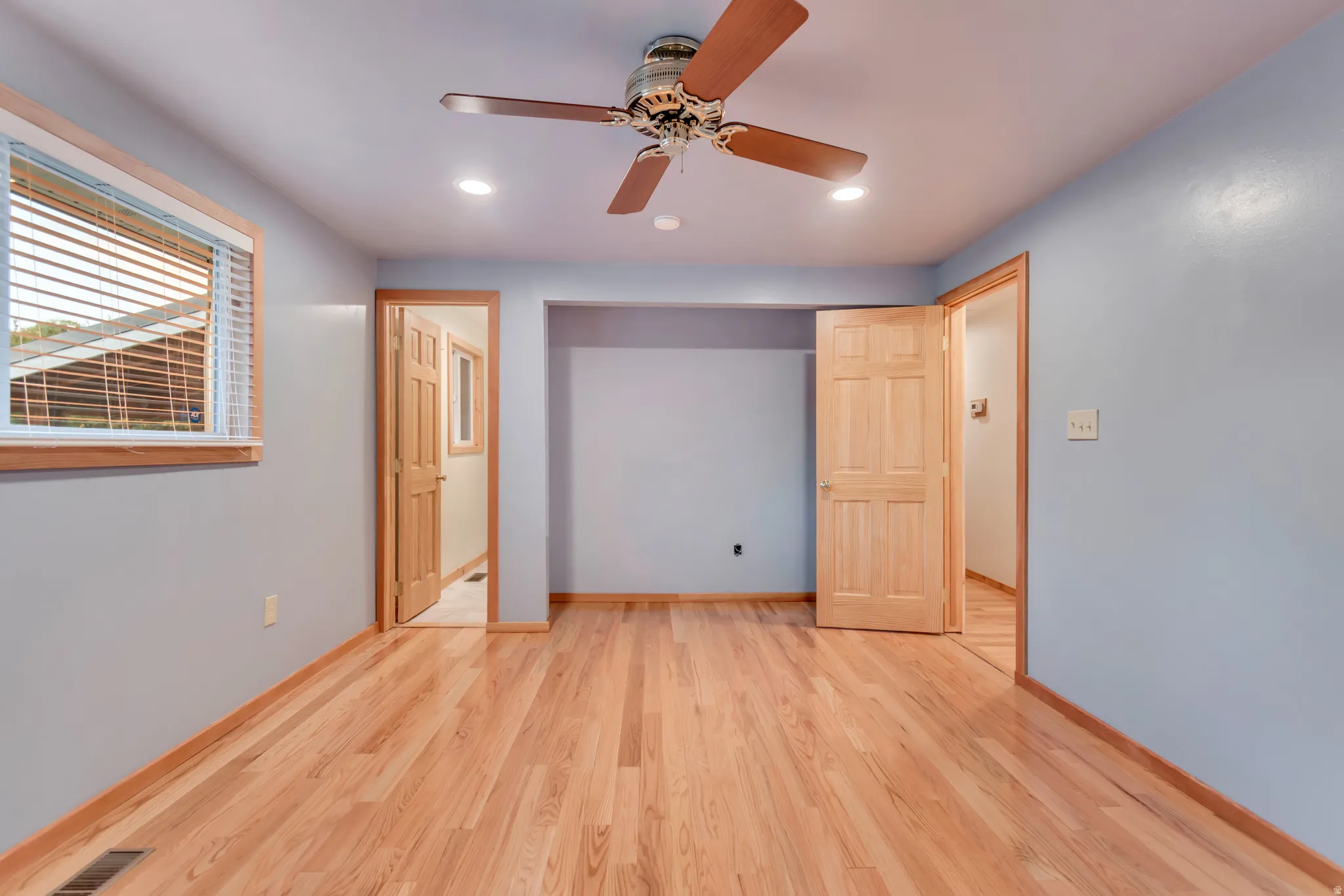 Unfurnished bedroom featuring light wood finished floors, recessed lighting, and a ceiling fan