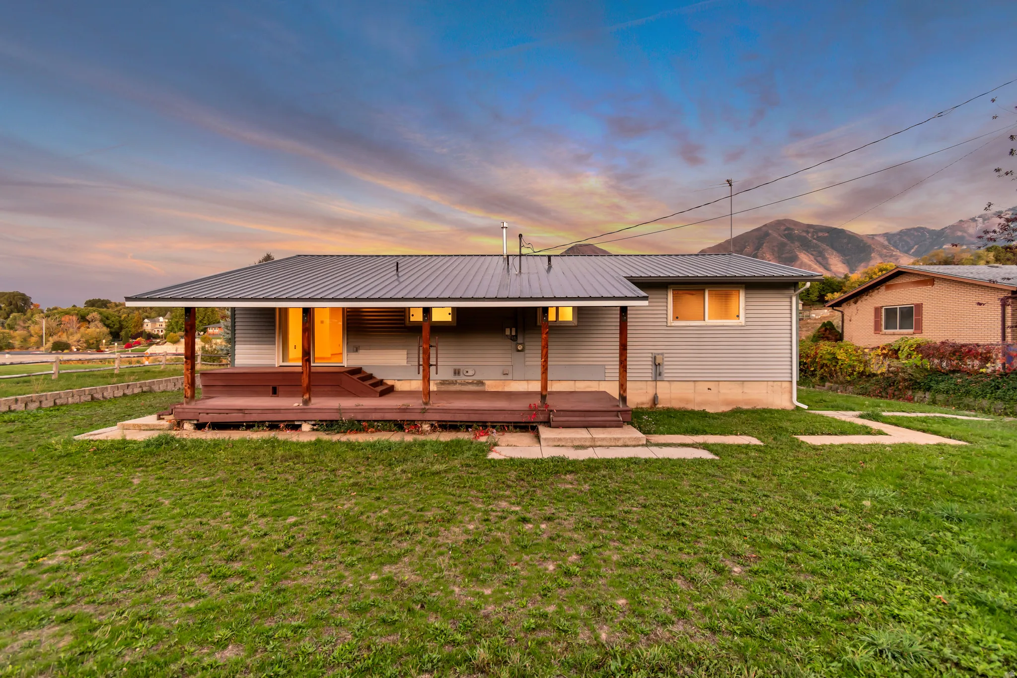 Rear view of property with a metal roof, a mountain view, and a porch